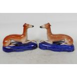 A pair of Staffordshire greyhound inkwells, 6½" long