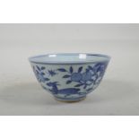 A Chinese blue and white porcelain rice bowl decorated with deer amongst trees, six character mark