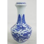 A Chinese blue and white porcelain vase with onion neck decorated with cranes and dragons amongst