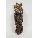 A Chinese carved and lacquered taper holder in the form of a flowering tree, 12" long
