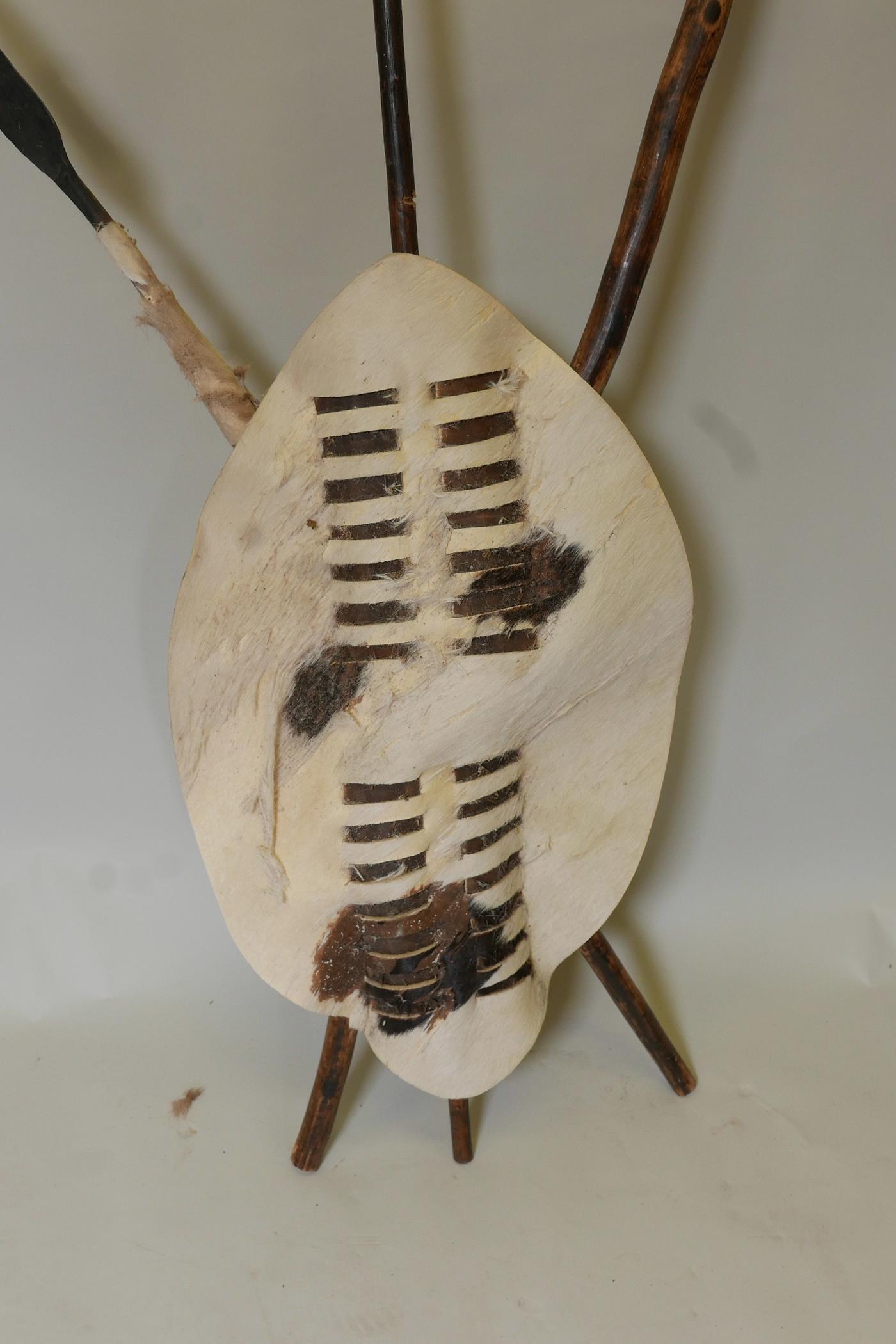 An African ceremonial display of leather shield with crossed club and spear, 7" long - Image 2 of 5