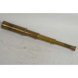 A brass cased three draw telescope marked Zeiss Germany, 6" long closed