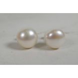 A pair of freshwater pearl stud earrings on silver posts