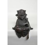 A Chinese cast bronze figure of a laughing sage with ruyi, 7½" high