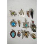 An assorted collection of twelve Indian stone set mixed metal pendants, rings and snuff bottles,