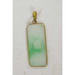 A gold mounted rectangular jade pendant, 1" long