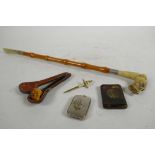 An eclectic lot containing a C19th Meerschaum pipe in the shape of a skull, a shoe horn with