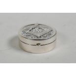 A 925 silver pill box with raised Masonic decoration to cover, 1" diameter