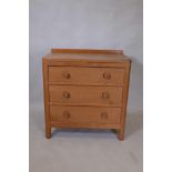 Foxman, Malcolm Pipes, a golden oak chest of three long drawers, with adzed top and panel sides, and