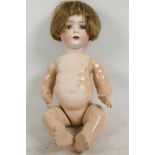 A Bruno Schmidt baby doll, model 2097-4, having bisque head with closing eyes, open mouth and no