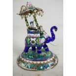 An Indian enamelled figure of an elephant with elaborate howdah decorated in bright colours,