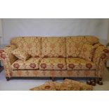 A good quality Ashley Lawrence three seat sofa with terracotta and gold upholstery, raised on turned