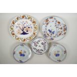 Four C18th Chinese export porcelain plates in the Imari and famille rose style, and an early C19th