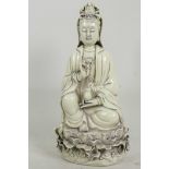 A Chinese blanc de chine porcelain figure of Quan Yin seated in meditation, 10" high