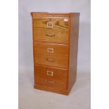 An oak three drawer filing cabinet with brass handles, 19" x 19" x 36"