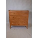 A mid C20th oak chest of four long drawers with matched veneers, and galleried top, raised on shaped