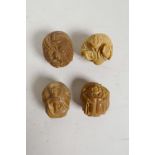 A set of four Japanese carved tagua nut netsuke in the form of mythical figures, 1" diameter