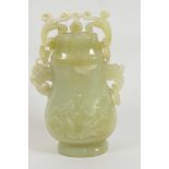 A Chinese carved jade jar and cover with retaining chain carved with elephant mask handles, 4¾" high