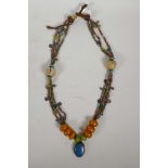 A string of ethnic beads including hardstone and amber, and a lapis pendant