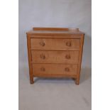 Foxman, Malcolm Pipes, a golden oak chest of three long drawers, with adzed top and panel sides, and