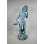 A verdigris bronze garden figure of Pan holding a branch with two perching birds, 26" high