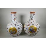 A pair of Chinese porcelain floor vases, decorated in bright enamels with butterflies and panels