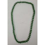 A string of apple green jade beads, 32" long