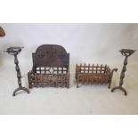 A pair of cast iron fire dogs, 22" high, and two wrought iron fire baskets, one 18" x 11" x 12", the