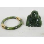 An oriental jade and gilt metal bangle, 3" diameter, together with a small carved hardstone figure