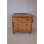 Foxman, Malcolm Pipes, a golden oak chest of three long drawers, with adzed top and panel sides, and