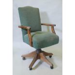 A tilt and swivel desk chair with reeded supports and castors