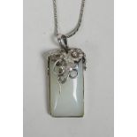A Chinese white metal and green hardstone pendant necklace, 2" drop