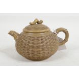 A Chinese Yixing teapot with a basket style body and bamboo style handle and spout, impressed mark