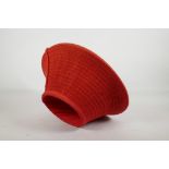 A Zulu woven framed hat, covered in red fabric, 15" wide