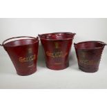 Three graduated metal buckets painted with Coca Cola design, largest 10½" high
