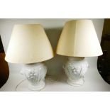 A pair of Continental white glazed ceramic table lamps of bulbous form with applied floral decoratio