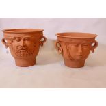 Martin Homer, a pair of studio terracotta planters, with raised mask decoration and ring handles,