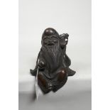 A Chinese cast bronze figure of a bearded sage, 7" high