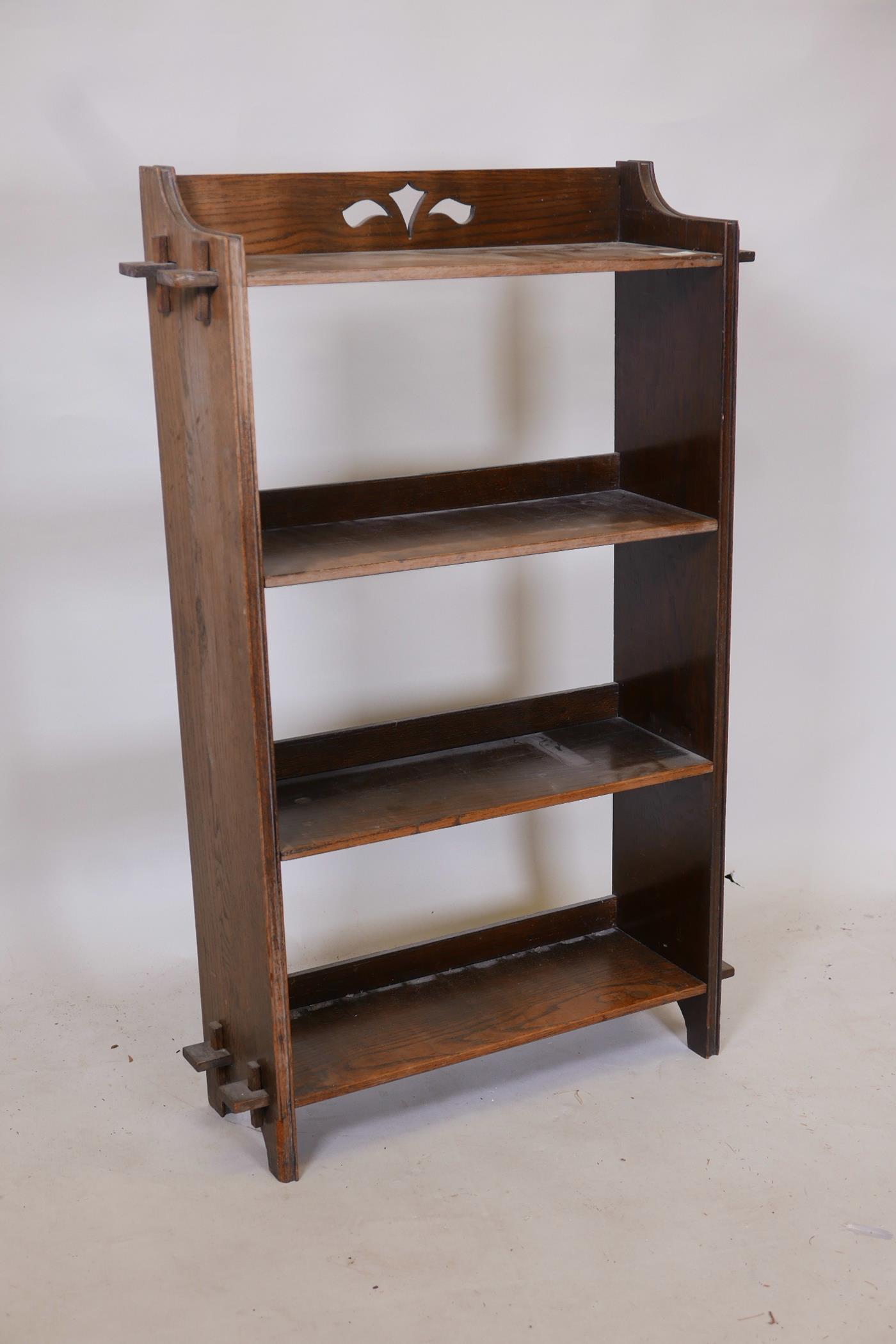 An Edwardian oak open bookcase with peg joined shelves, 25" x 40" x 8"