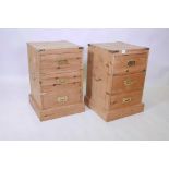 A pair of military style pine three drawer bedside chests with brass drop handles, 24" x 15" x 15"