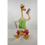 A Pop Art wooden figure of a duck writing notes whilst listening to the radio, 22" high