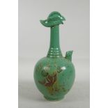 A Chinese green glazed pottery wine pourer with phoenix head decoration to top, the body decorated