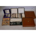 Four boxed sets of silver plated fish eaters, a vintage boxed stainless steel carving set with