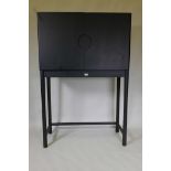 A contemporary black cabinet on stand, the interior fitted with four drawers, 39½" x 18", 60" high