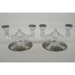 A pair of glass two light table candelabrum, with silver overlaid decoration of leaves and