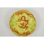 A Chinese polychrome porcelain dish decorated with red dragons on a yellow ground, 6 character