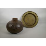 An antique African iron pot, A/F, 12" diameter, together with an engraved brass dished tray, 14"