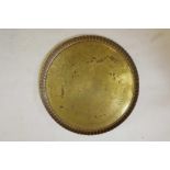 A large Islamic brass tray decorated with scrolling patterned decoration and Islamic script, 31"