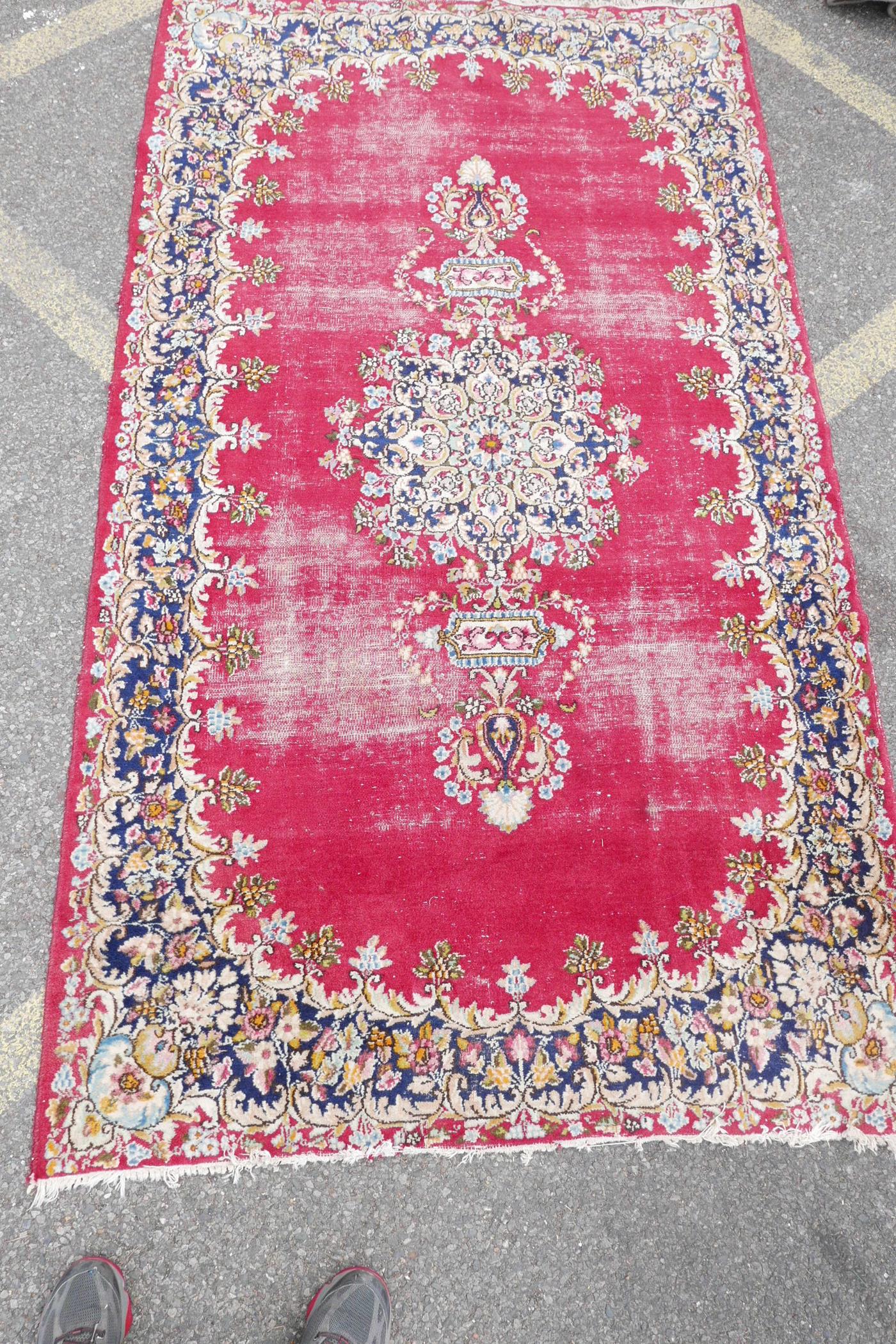 A red ground oriental pattern rug with ornate floral border (worn), 89" x 50" - Image 2 of 3