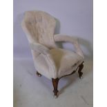 A Victorian walnut open arm, shaped back easy chair, 35" high